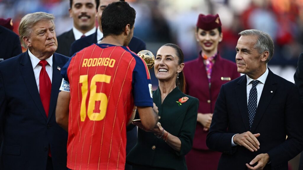 Soccer Football - FIFA World Cup 2026 - Final - Spain v Argentina - New York/New Jersey Stadium, East Rutherford, New Jersey, U.S. - July 19, 2026 Spain's Rodri receives the Golden Ball award from Mexican President Claudia Sheinbaum as Canada Prime Minister Mark Carney and U.S. President Donald Trump look on REUTERS/Dylan Martinez